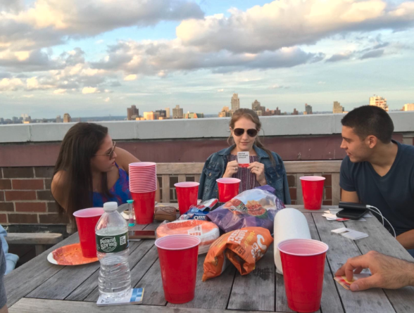 Overcoming Your Fear of Entertaining [3 Powerful Ways] - Friends on rooftop playing card game