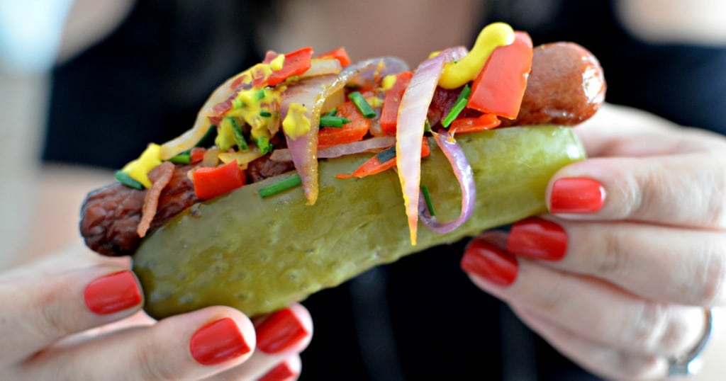 Woman holding pickle dog in hands - 11 Fun Things To Do On This  Labor Day Weekend