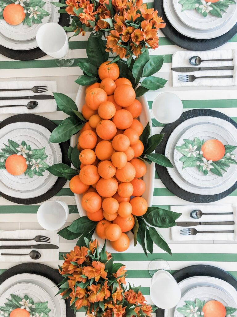 fall tablescape with green leafs and oranges