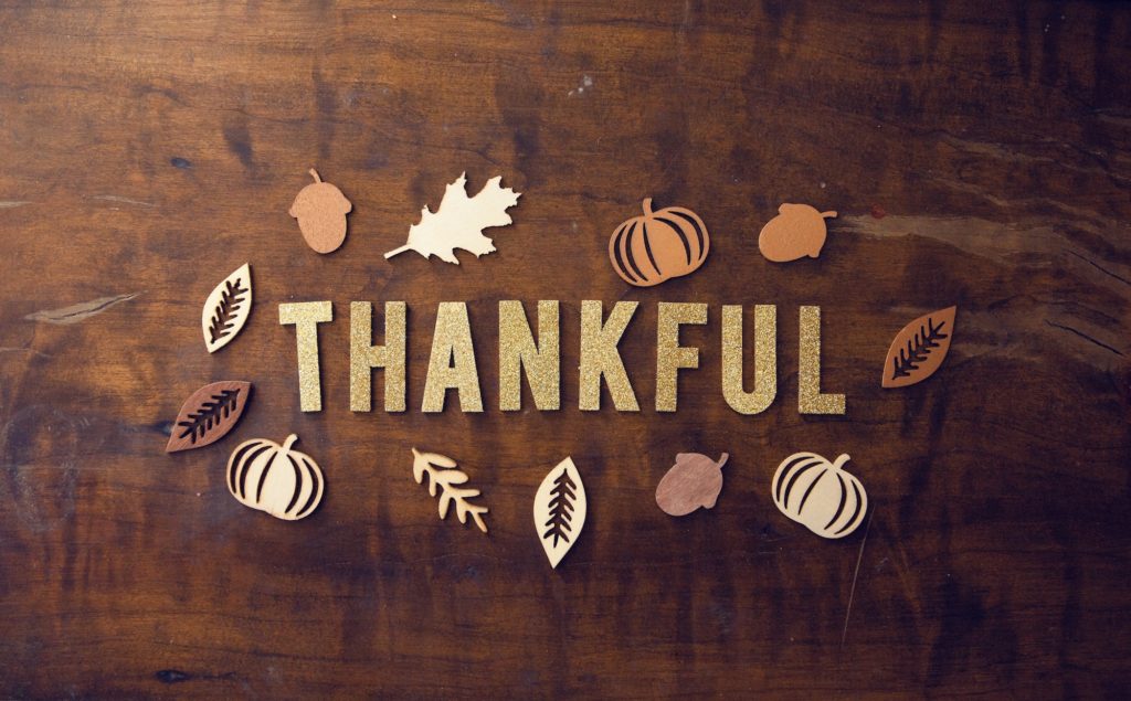 the word thankful on a flat lay piece of wood 