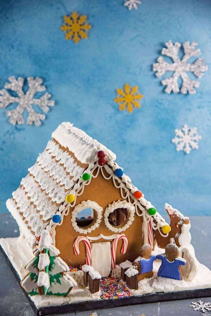 gingerbread house on a blue winter backdrop