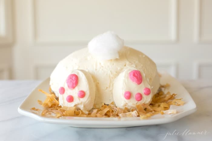 a bunny butt cake on a bed of coconut flakes