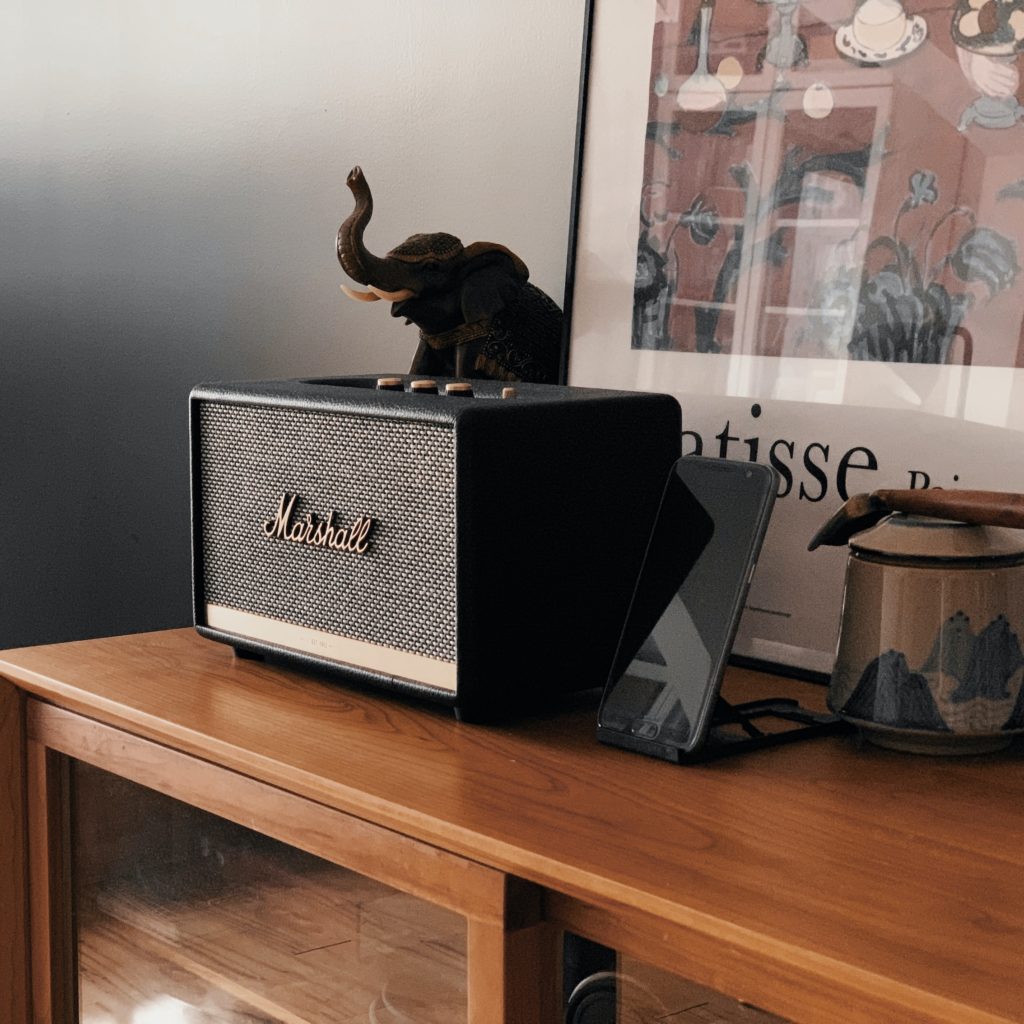 music speaker on a wooden table with an elephant on top of it 