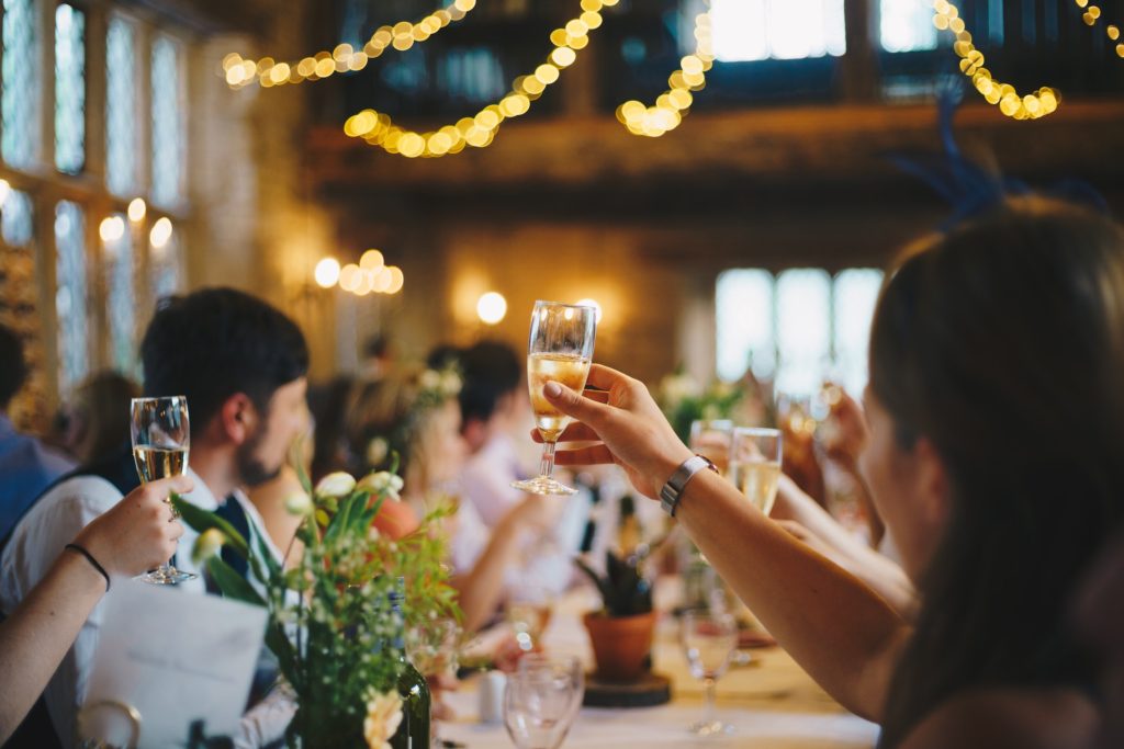 group of people holding up their glasses for a toast - casual conversation starters