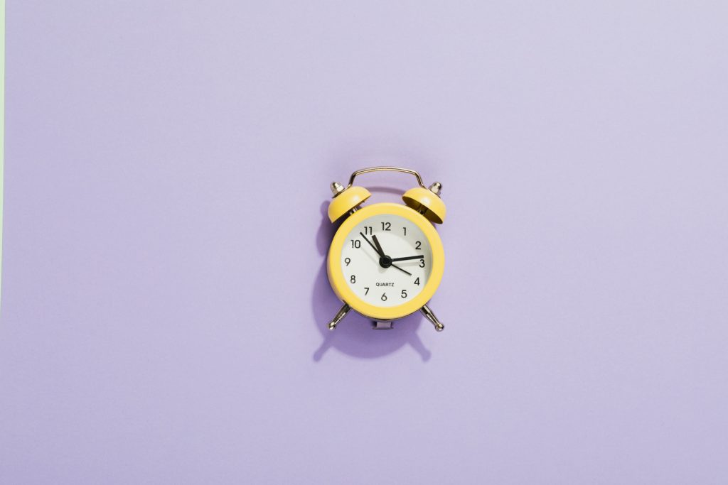 yellow clock on a purple background