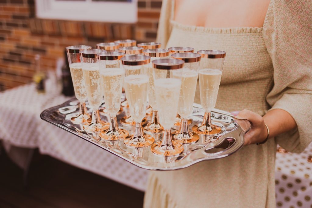 lady holding a tray of champagne