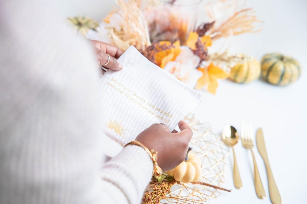 Convokins napkins held by black woman at dinner table