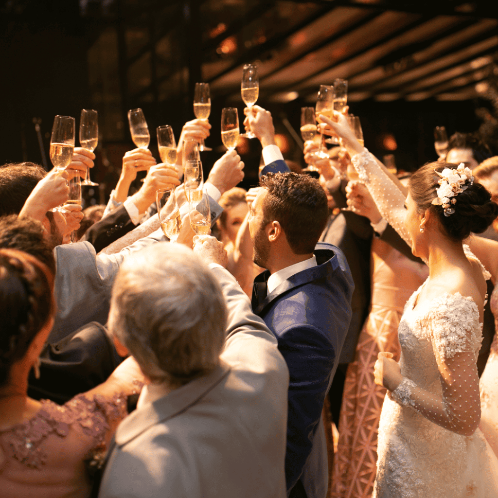 wedding guests cheering to bride and groom