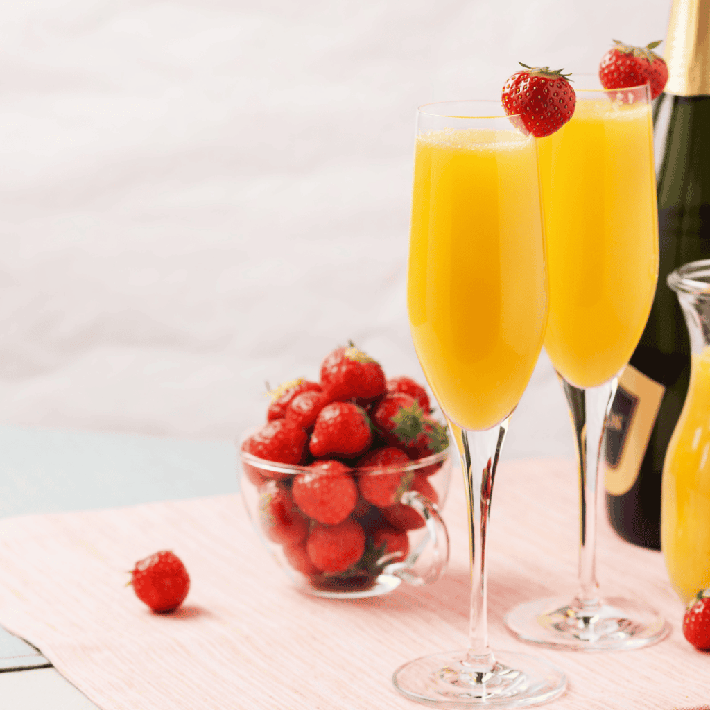 mimosas garnished with fruit at a party