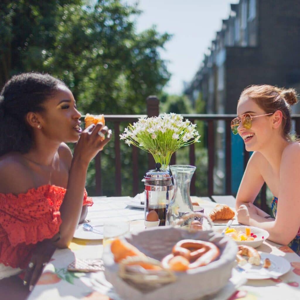 friends having fun and laughing at a lazy sunday brunch party