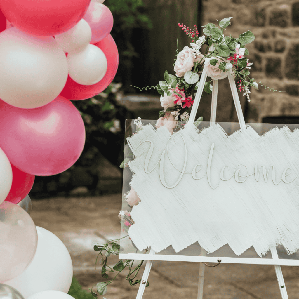 rose themed baby shower with sign and balloons