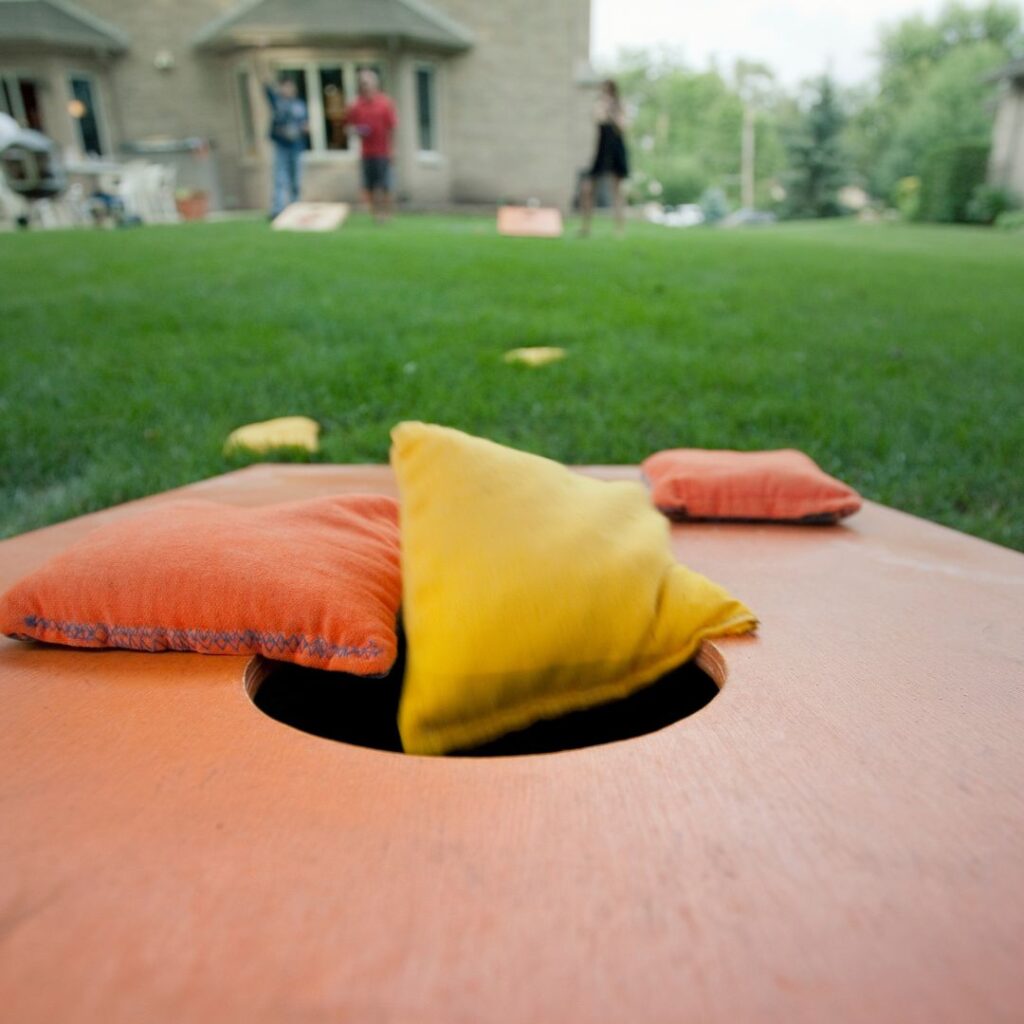 playing cornhole at a 30th birthday party